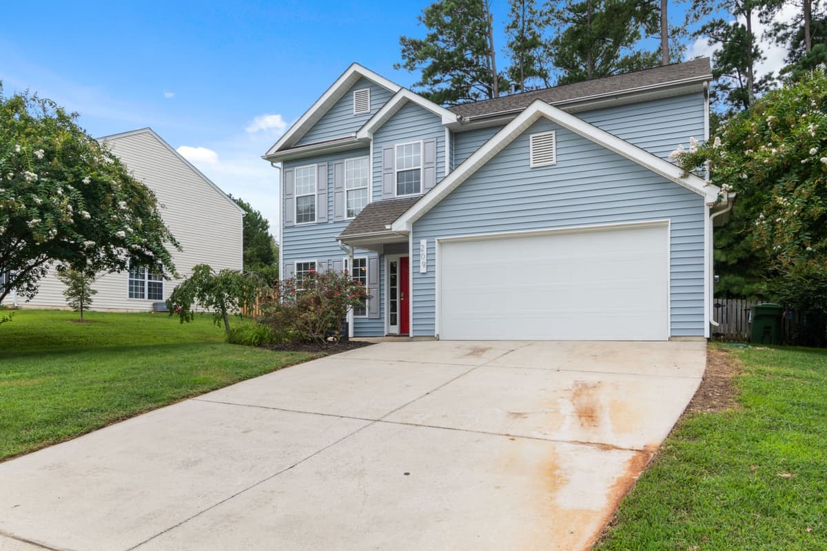 Two-story suburban house with a driveway and front lawn