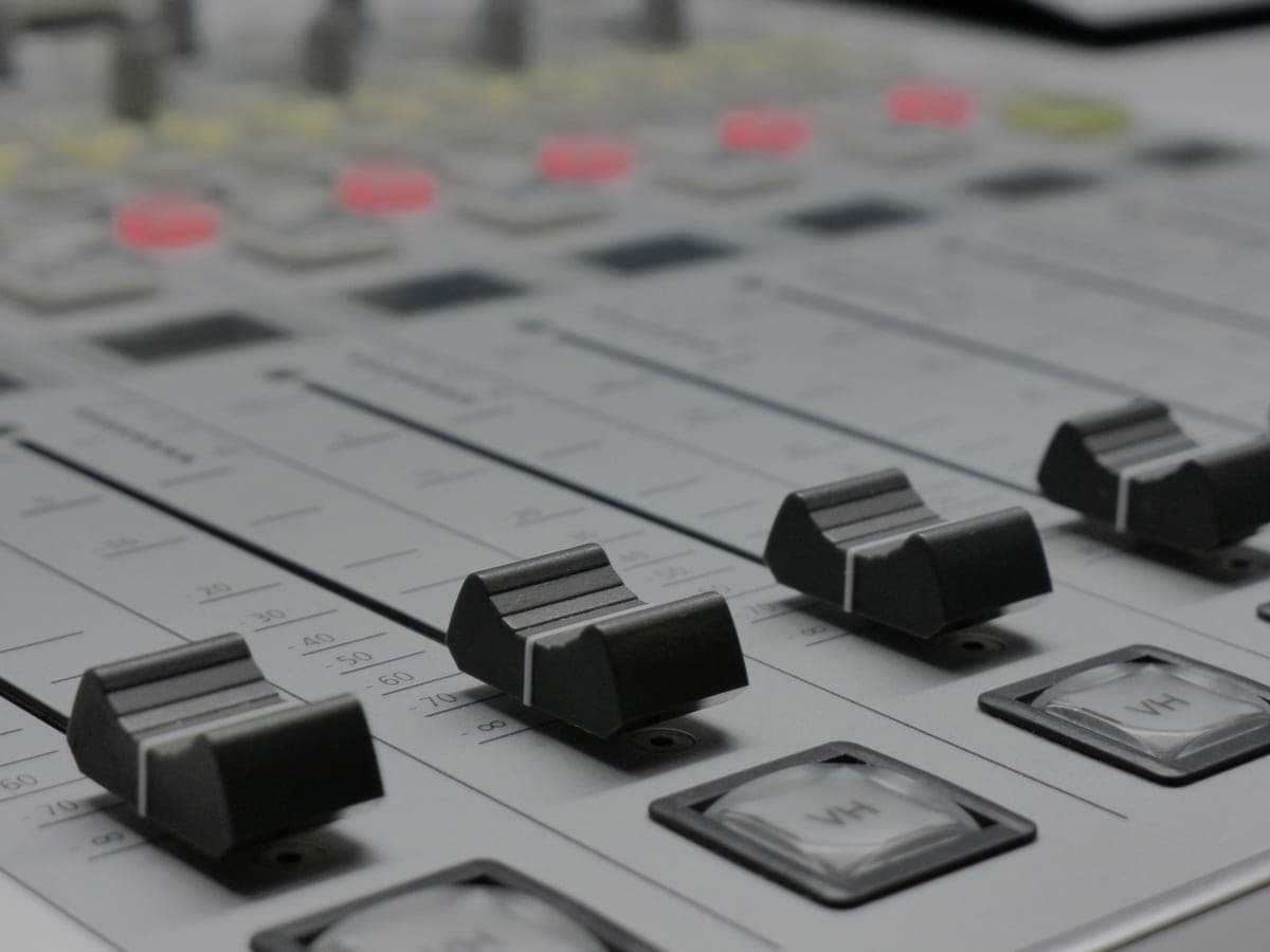 Close-up of the faders on an audio mixing console